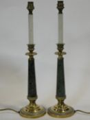 A pair of vintage brass and marble table lamps in the form of candles in their stands. H.51cm