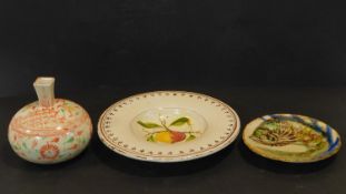 A collection of hand painted ceramics. Including a Majolica glazed ceramic charger with fish design,