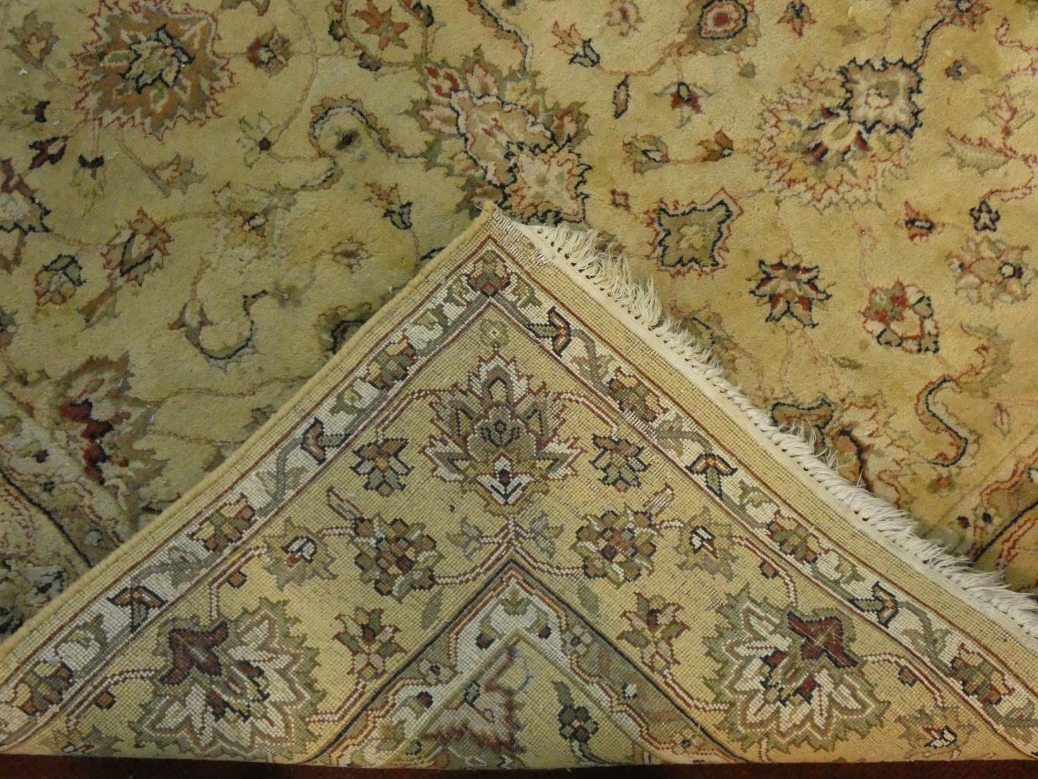 A Persian style rug with all over naturalistic scrolling floral decoration on a cream ground - Image 3 of 4