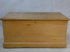 A 19th century pine hinged lidded travelling trunk with twin iron carrying handles. H.50 L.101 W.