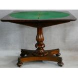 A mid Victorian mahogany foldover top card table raised on shaped reeded pedestal on quattreform