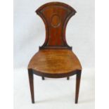 A Regency mahogany hall chair with shield back and central roundel above panel seat on square