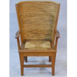 An oak framed Orkney Islands child's armchair with curved plaited ropework back and drop in seat