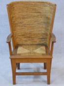 An oak framed Orkney Islands child's armchair with curved plaited ropework back and drop in seat