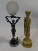 An Art Deco style figural table lamp with opaque glass globe shade and a Chinese moulded figure of a