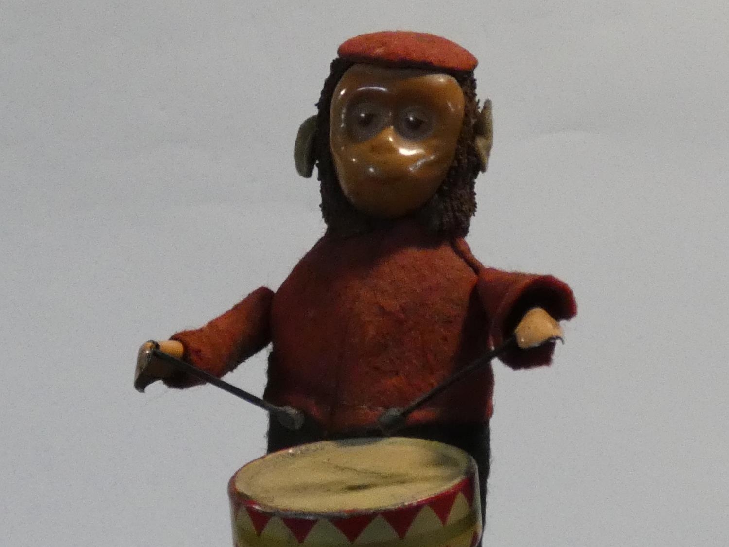 A Schuco patent drumming monkey clockwork toy, with makers mark to foot. No Key. H.11cm - Image 7 of 7