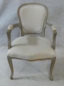 A Louis XV style grey painted fauteuil in pale calico upholstery on cabriole supports. H.95cm