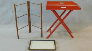 A red painted 19th century butler's tray on a folding stand, a lacquered twin handled tray and a