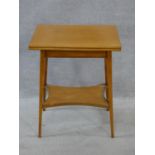 An Edwardian satin birch foldover top games table on splayed square tapering supports united by