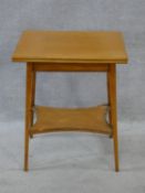 An Edwardian satin birch foldover top games table on splayed square tapering supports united by