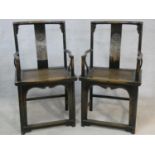 A pair of mid century Chinese hardwood armchairs with carved character marks to the back splats
