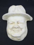 A wall hanging moulded plaster cast, face mask of Winston Curchill. 20x16cm