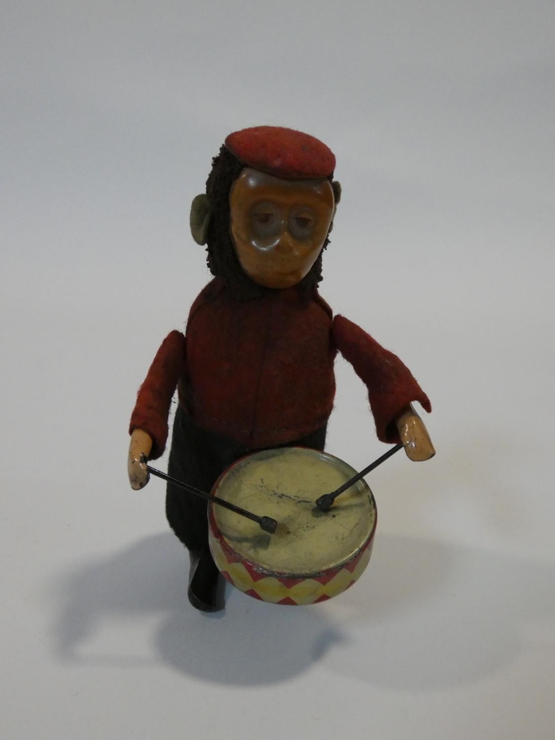 A Schuco patent drumming monkey clockwork toy, with makers mark to foot. No Key. H.11cm