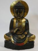 A large Oriental carved wooden painted and gilded Buddha sculpture H.56cm