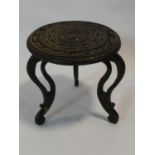 A small Indian hardwood occasional table with carved top and cabriole supports. H.30xD.30cm