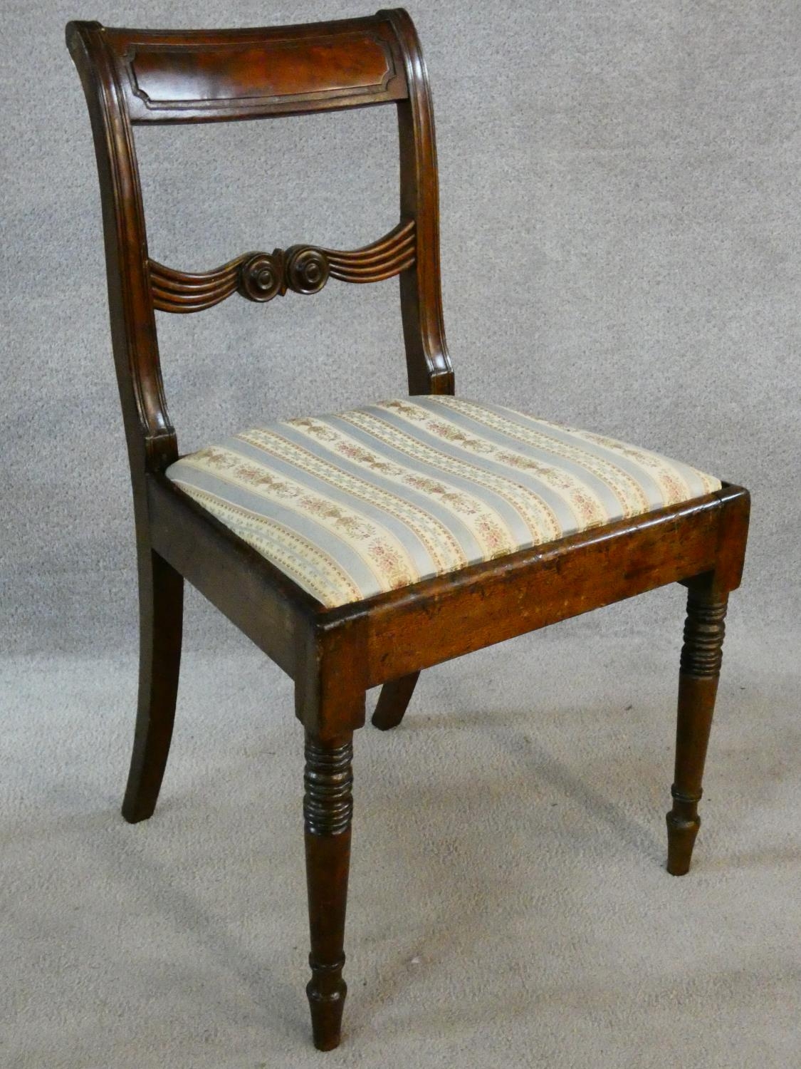 A pair of late Georgian mahogany dining chairs with carved bar backs and splats above drop in - Image 3 of 8