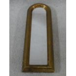 A small narrow arched gilt and moulded framed pier mirror. 54x18cm