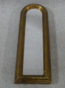 A small narrow arched gilt and moulded framed pier mirror. 54x18cm