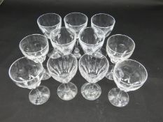 Eleven cut crystal sherry glasses with faceted petal design. H.15cm