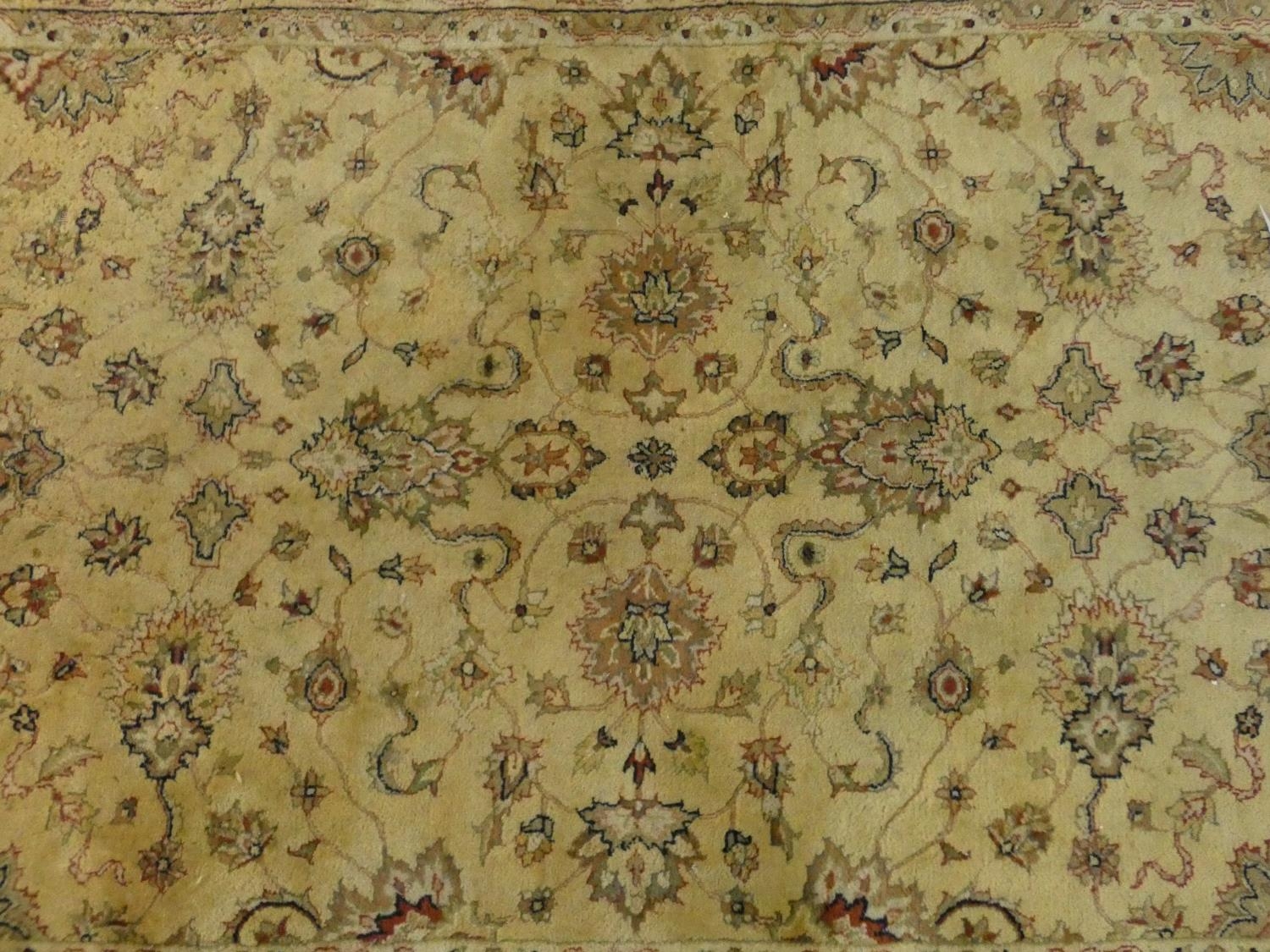 A Persian style rug with all over naturalistic scrolling floral decoration on a cream ground - Image 4 of 4