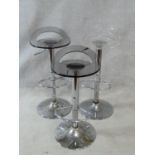 Three bar stools with moulded perspex seats and rise and fall action on chrome tulip bases. H.86cm
