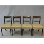 A set of four late Georgian mahogany bar back dining chairs with ebony Greek key pattern inlay above