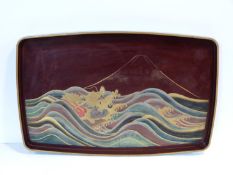 A Meiji period Japanese gilded lacquered painted tray. Depicting a dragon among the waves with Mount