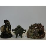 A Chinese carved soapstone lidded censer, a soapstone Dog of Fo on carved wooden base and a