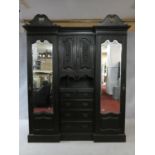A late 19th century carved mahogany three section compactum wardrobe fitted with central drawers