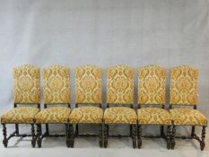 A set of six Jacobean style oak framed high back dining chairs in gold cut floral upholstery on