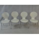 A set of four Arne Jacobsen style chairs in leather upholstery on tubular chrome frames. H.86cm