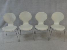 A set of four Arne Jacobsen style chairs in leather upholstery on tubular chrome frames. H.86cm