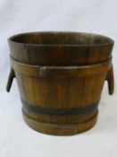 A Chinese coopered and iron bound hardwood twin handled water bucket. H.51xW.57xL.44cm