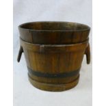 A Chinese coopered and iron bound hardwood twin handled water bucket. H.51xW.57xL.44cm