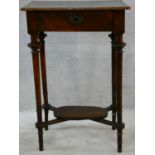 A 19th century French walnut lamp table with fitted frieze drawer on turned tapering supports united