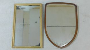 A gilt framed wall mirror and a mahogany framed shield shaped mirror. H.82xW.52cm