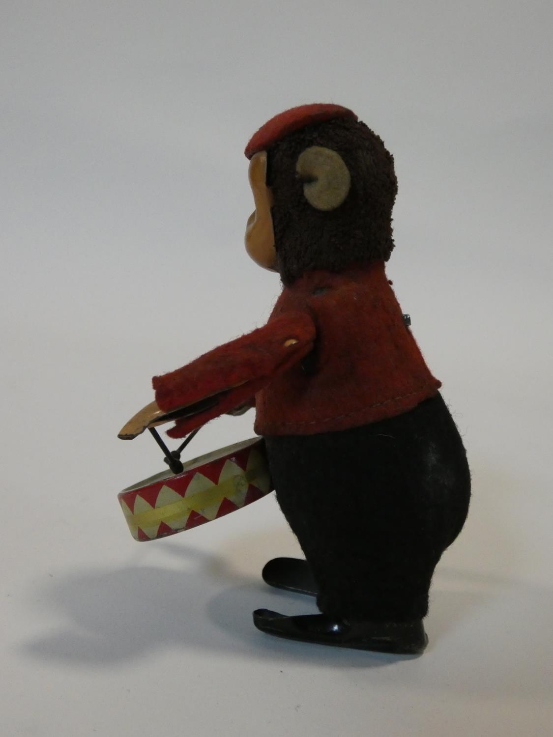 A Schuco patent drumming monkey clockwork toy, with makers mark to foot. No Key. H.11cm - Image 3 of 7