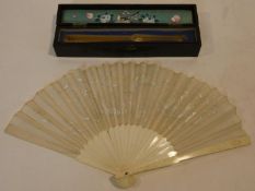 A Japanese carved bone fan with silk embroidered dragon design in fitted lacquered box with