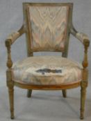 A 19th century Louis XVI style painted pitch pine fauteuil. H.86cm (upholstery and paint worn)