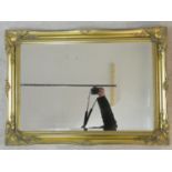 A contemporary wall mirror in scrolling gilt frame. 65x90cm