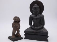 An Carved Eastern hardwood figure of the seated Buddha and a clay carving of an African tribal