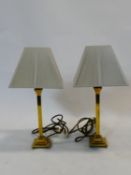 A pair of contemporary brass table lamps on stepped bases. H.42cm