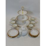 A porcelain six person tea service with 22ct gold highlights by Imperial, includes a three tier cake
