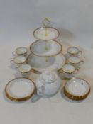 A porcelain six person tea service with 22ct gold highlights by Imperial, includes a three tier cake