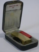 A cased 'Rollagas' gold plated Dunhill lighter with spare flints and cleaning brush and with