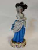 An antique Levy & Co porcelain hand painted figure of a lady in a blue dress with feather hat,