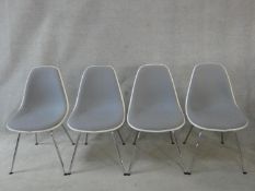 A set of four Eames style moulded and upholstered chairs for Vitra on chrome tubular supports. H.