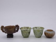 A pair of Chinese spinach jade bowls, a small soapstone bowl and another soapstone bowl with twin