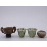 A pair of Chinese spinach jade bowls, a small soapstone bowl and another soapstone bowl with twin