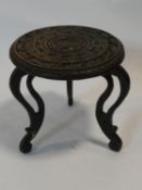 A small Indian hardwood occasional table with carved top and cabriole supports. H.30xD.30cm